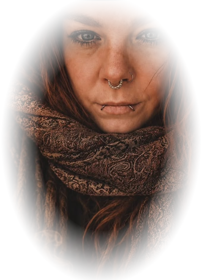 Rain, smiling softly, wrapped in a woven scarf